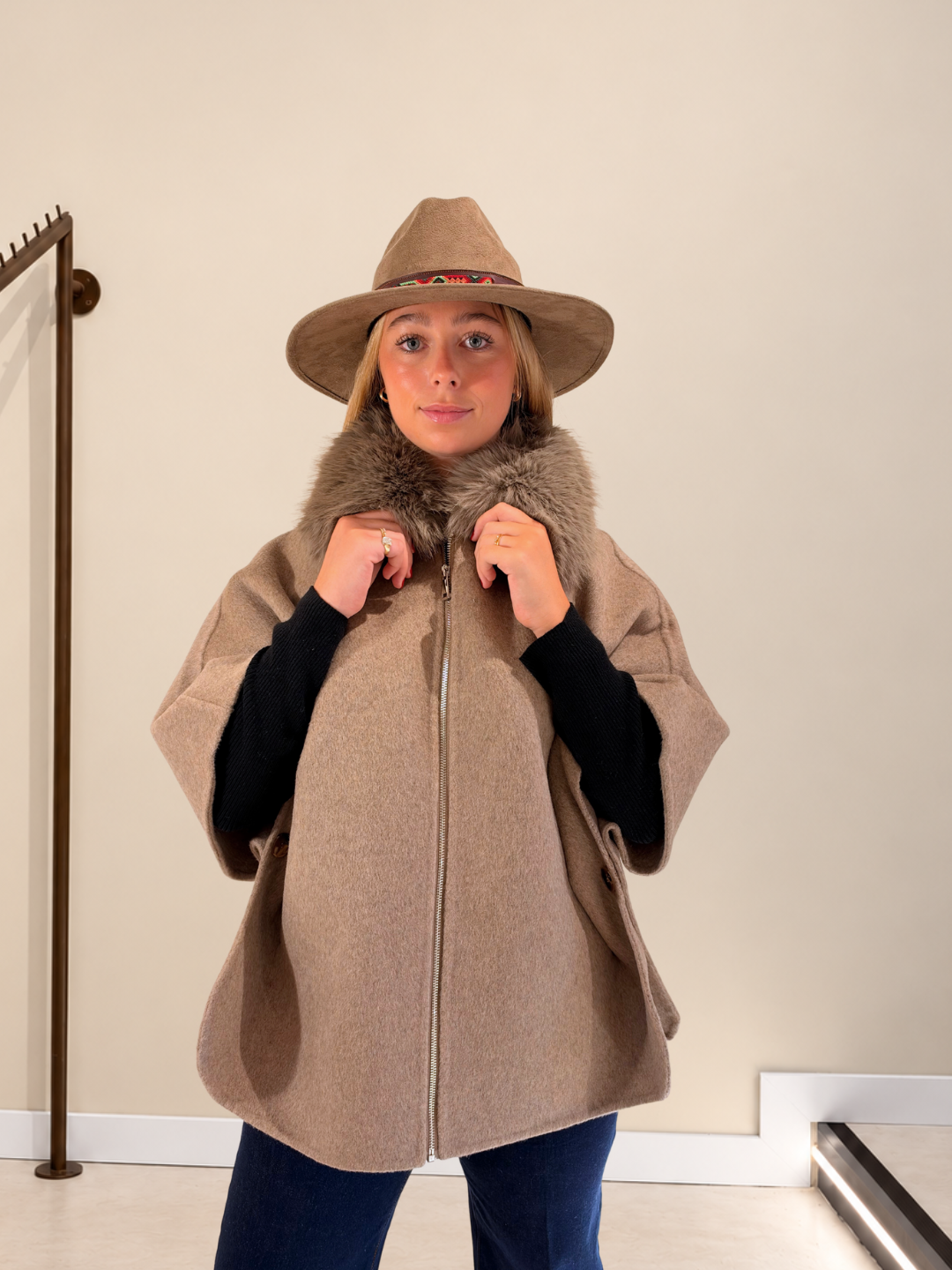 Capa Alaska beige de paño con cuello de pelo y sombrero de fieltro, abrochada con cremallera